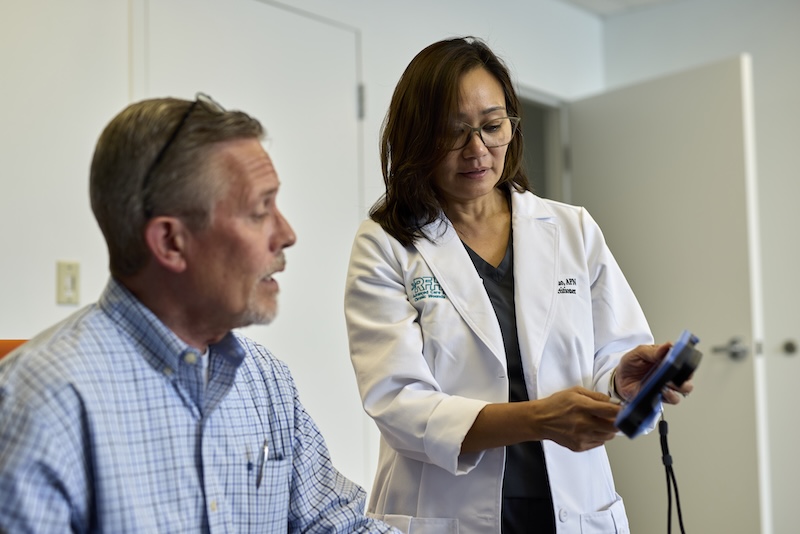 Nurse showing patient test data at the patient's home